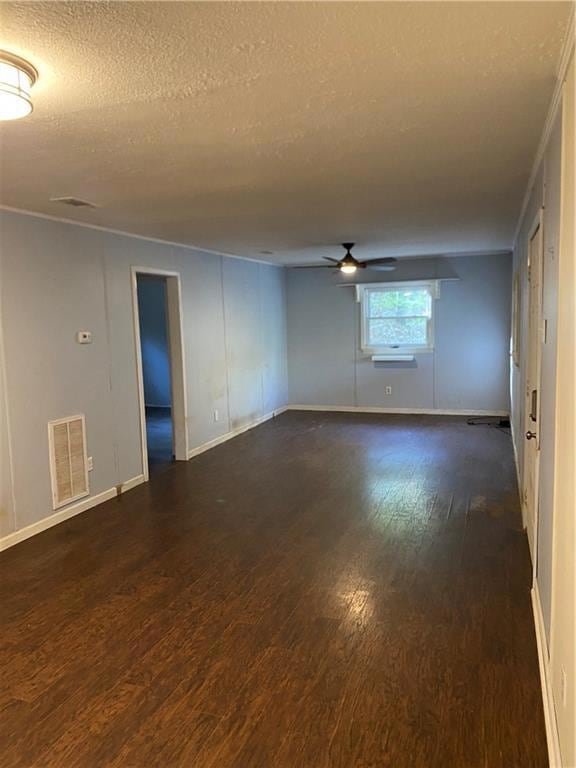 Unfurnished room featuring a textured ceiling, dar