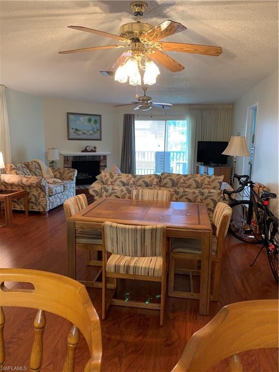 Dining/living area looking from kitchen pass-thru to screened balcony.