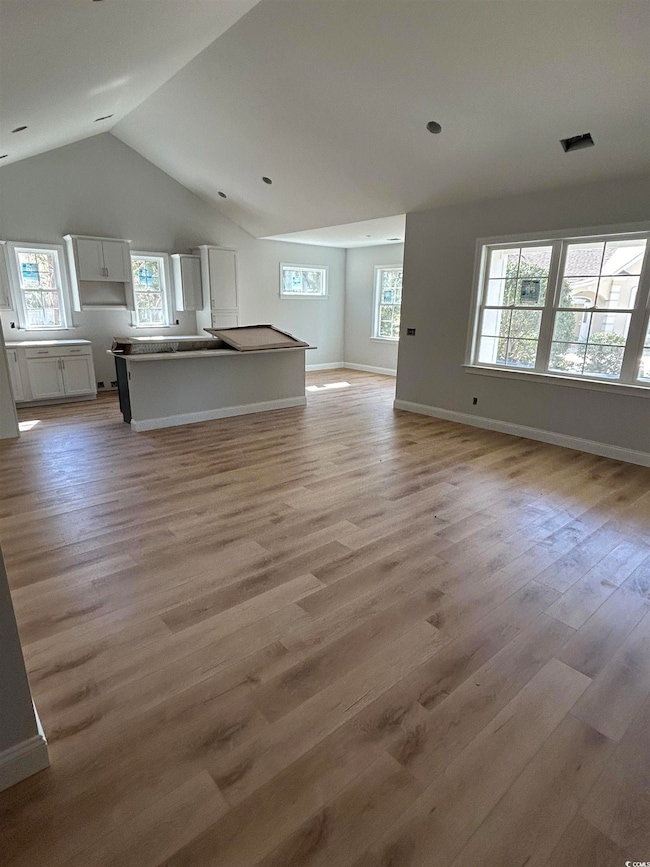 Unfurnished living room featuring baseboards, visi