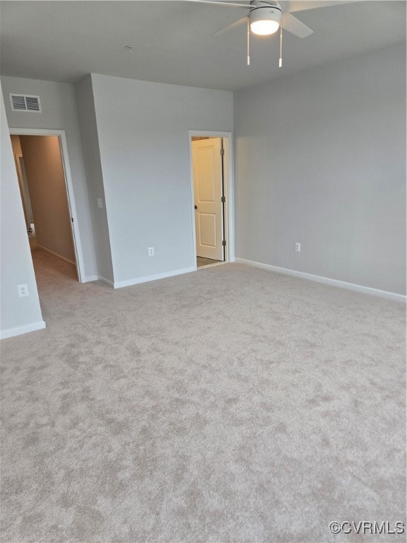 Empty room with a ceiling fan, visible vents, carp