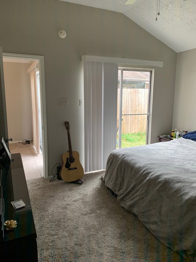 Nice sized master bedroom with updated carpet and view to the patio/backyard area.
