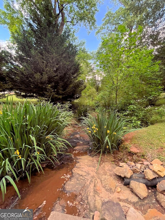 To have a creek running through the front yard is to possess a living corridor of beauty and vitality-a space always shifting, always alive. It offers more than visual pleasure; it connects the home to the land.