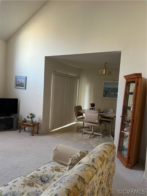 Carpeted living room with a notable chandelier and