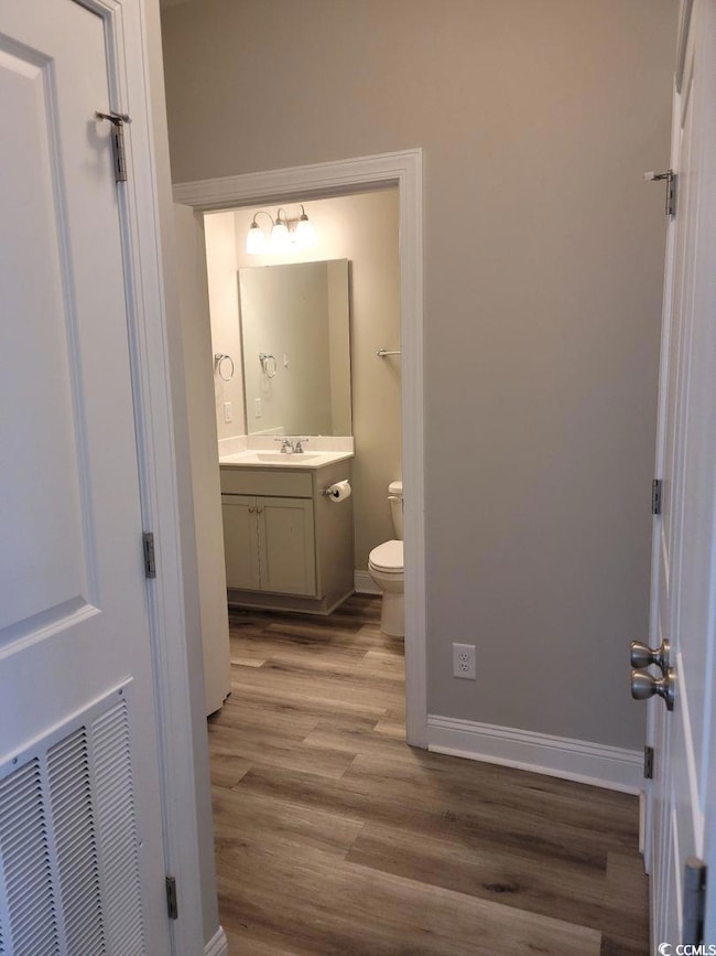 Bathroom featuring visible vents, baseboards, toil