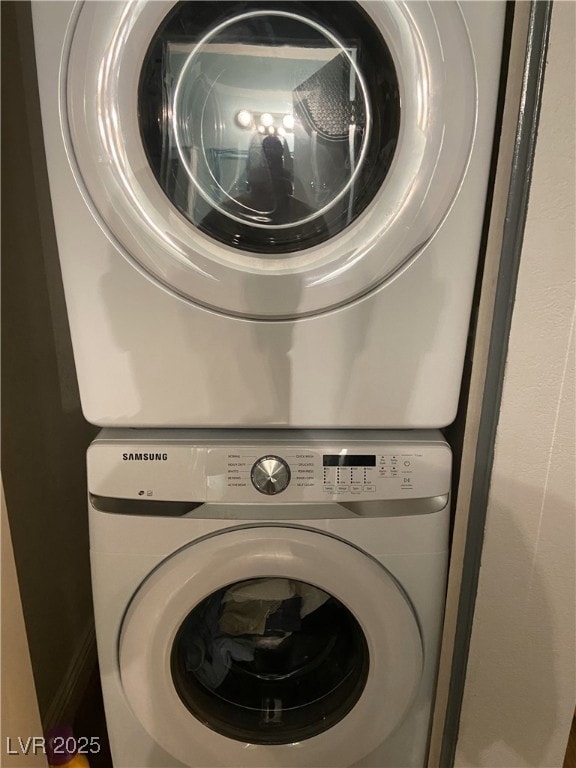 Laundry room featuring stacked washer and clothes