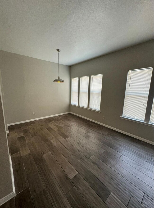 Unfurnished room with dark wood-type flooring, ba