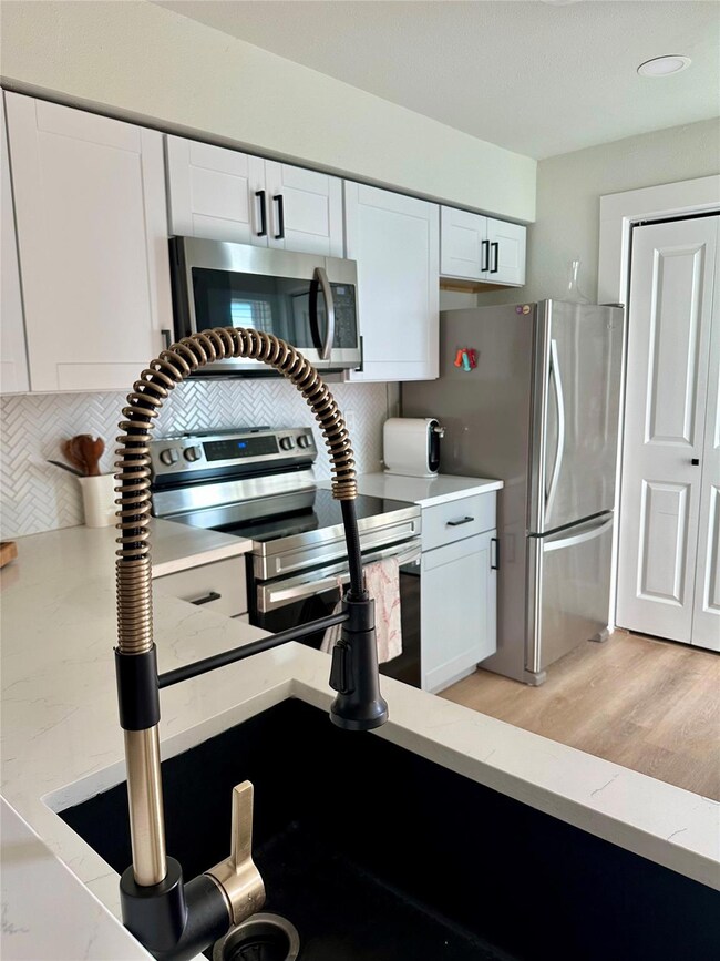 Kitchen featuring decorative backsplash, stainles