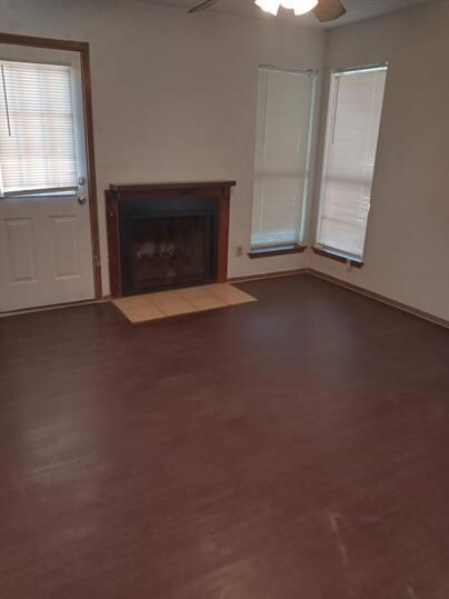 Unfurnished living room featuring wood finished f