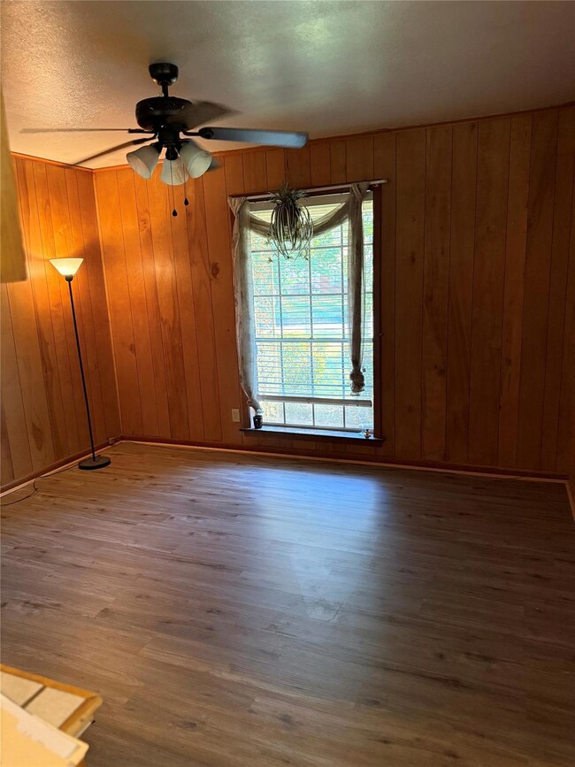 Spare room featuring wooden walls, wood finished f