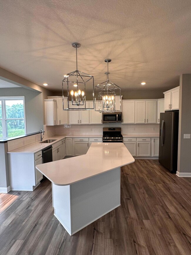 This kitchen is stunning! Huge center island, ample countertop place and is flooded with natural light!