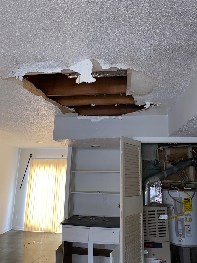 Room details with a textured ceiling, electric wat