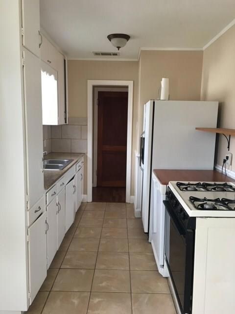Kitchen with gas range.  Fridge stays!