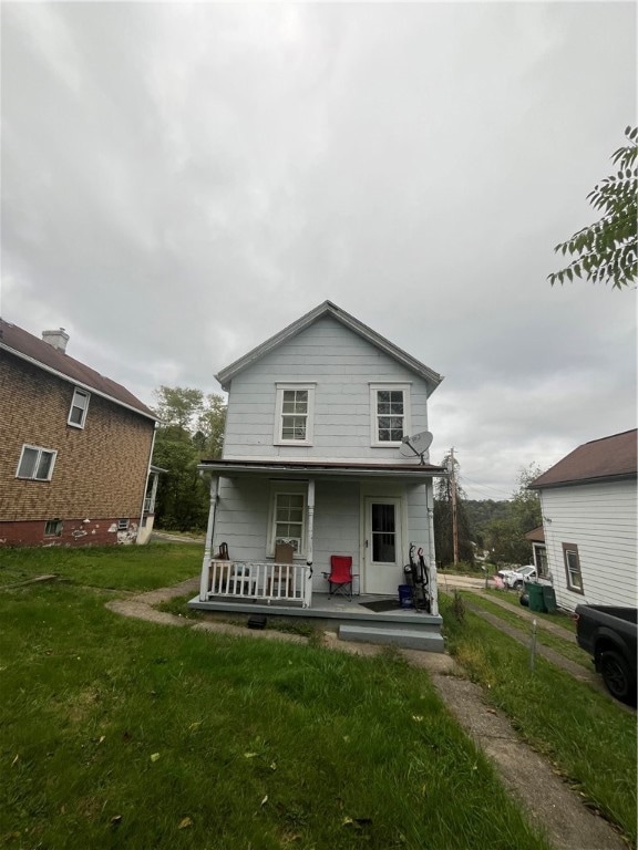 Rear of the home with a cozy covered porch.
