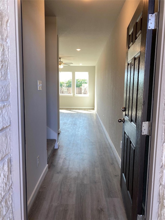 Hall with wood finished floors and baseboards