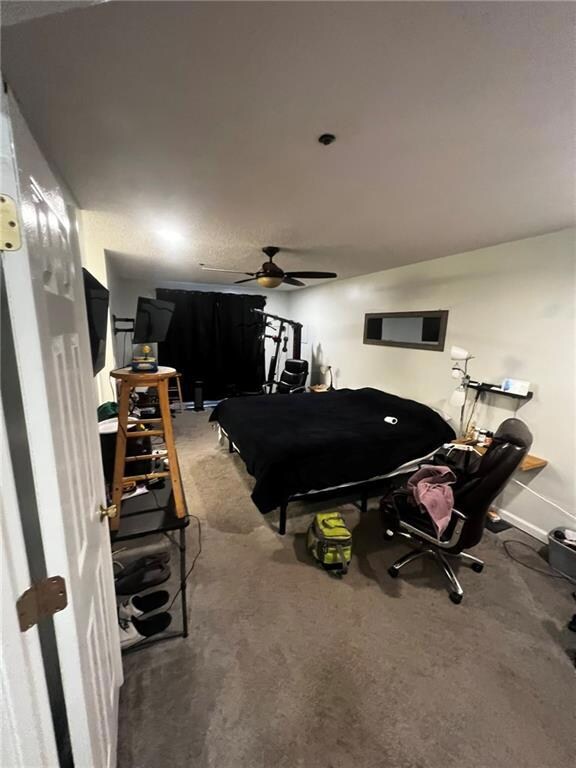 Bedroom featuring baseboards and light colored car
