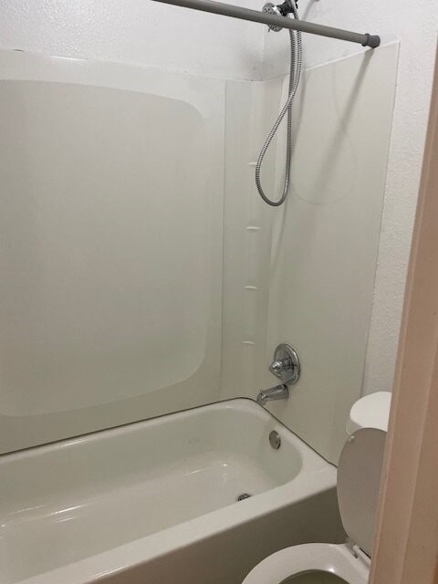 Bathroom with tub / shower combination and toilet