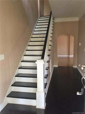 welcoming open raiiled stairs in front hall
