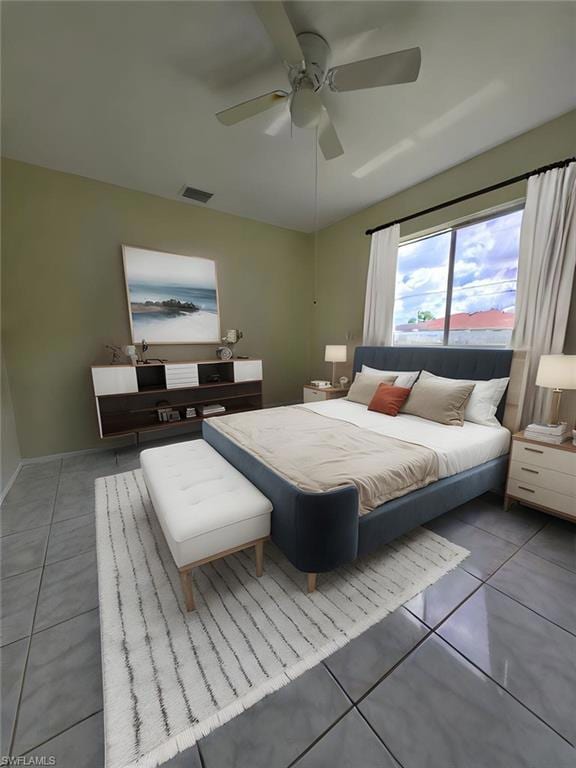 Bedroom featuring tile patterned floors and a ceiling fan