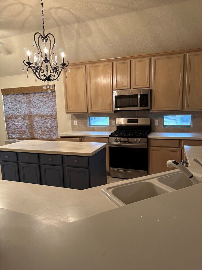 Kitchen with corian countertops.