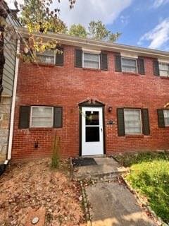 Colonial home with brick siding