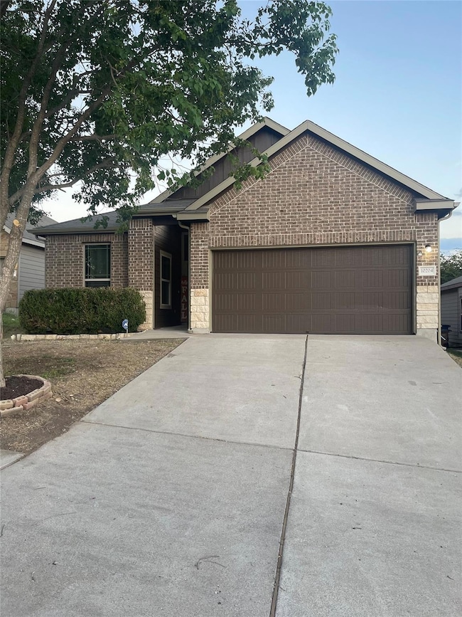 Ranch-style house with brick siding, concrete dri