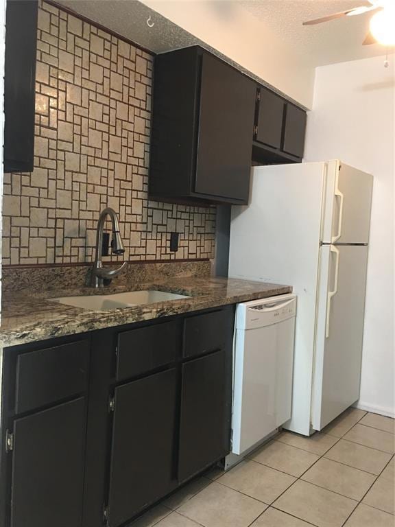 Kitchen with dishwasher, tasteful backsplash, a textured ceiling, light tile patterned floors, and ceiling fan