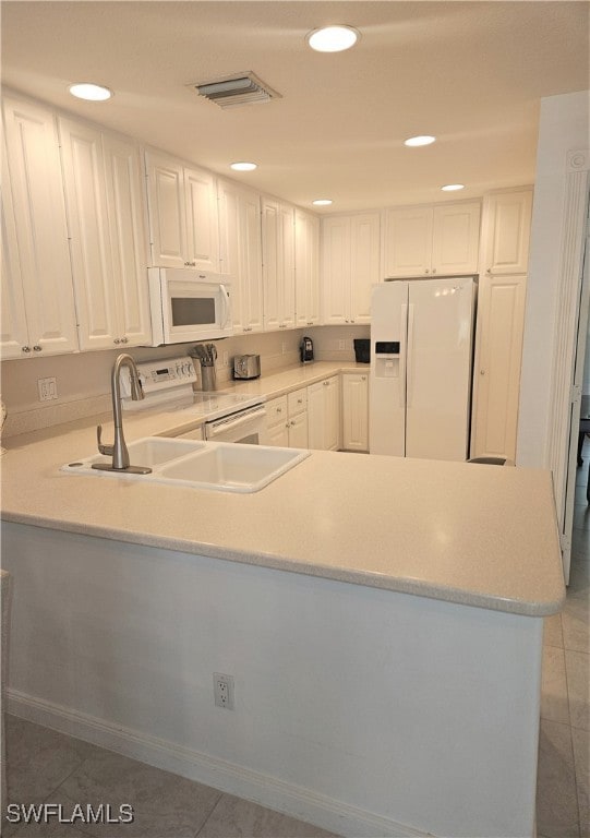 Kitchen featuring kitchen peninsula, sink, light t