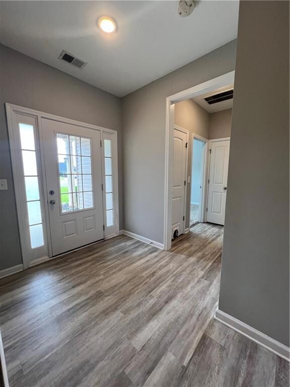 Entryway featuring baseboards and light wood-style flooring