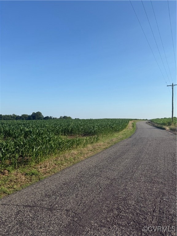 View of asphalt road with a rural view and agricul