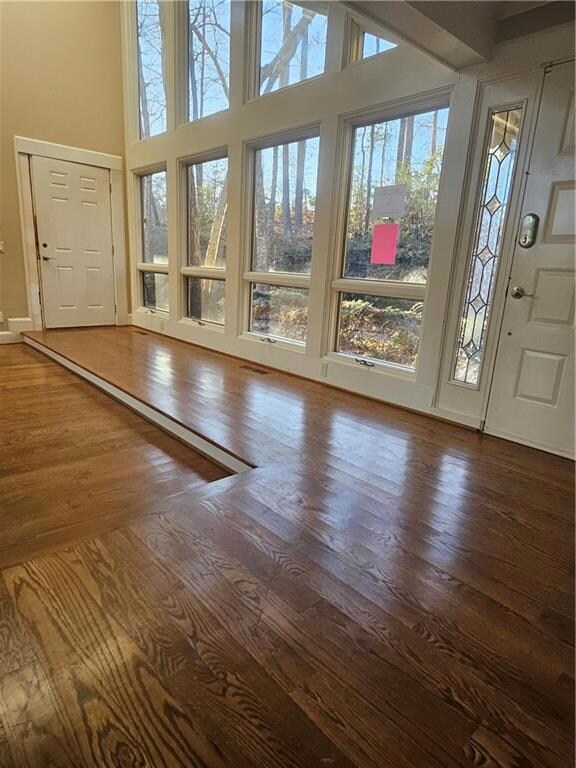 Foyer entrance featuring wood-flooring and a high 