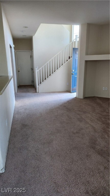 Empty room with carpet flooring and baseboards
