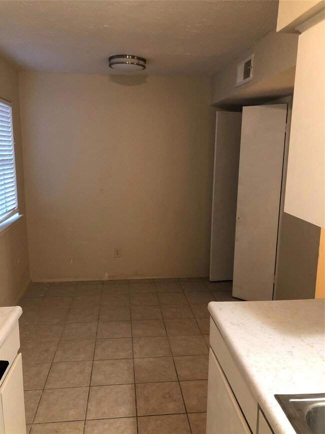 Kitchen featuring white cabinets and light tile pa