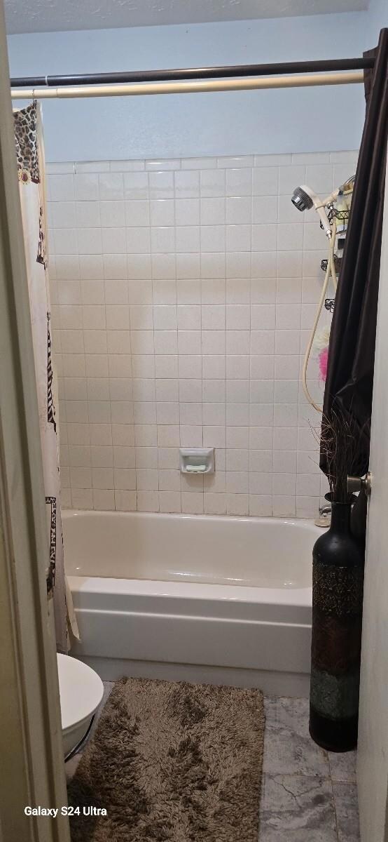 Bathroom featuring shower / bath combination with 
