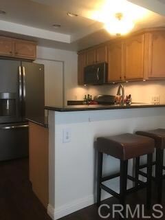 Kitchen has bar area.