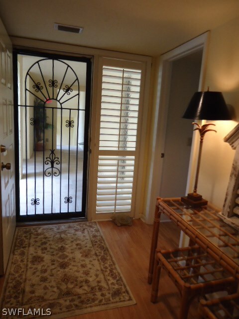 Elegant entryway w/ plantation shutters & wrought-