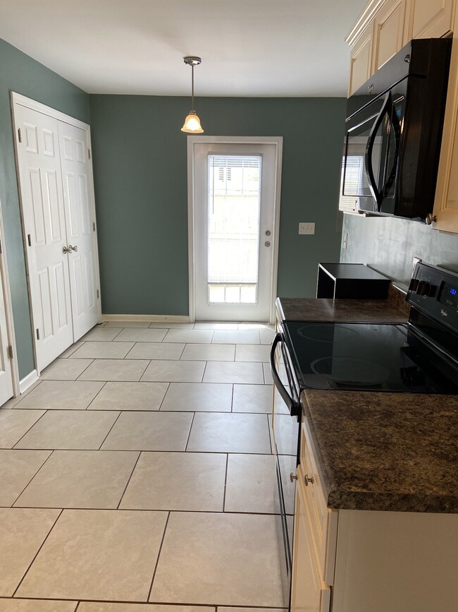 view of kitchen eat in area and the laundry room ids behind those doors to the left.