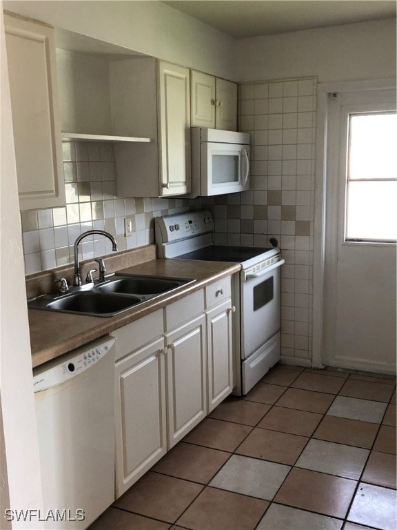 Kitchen with light tile patterned floors, dishwash