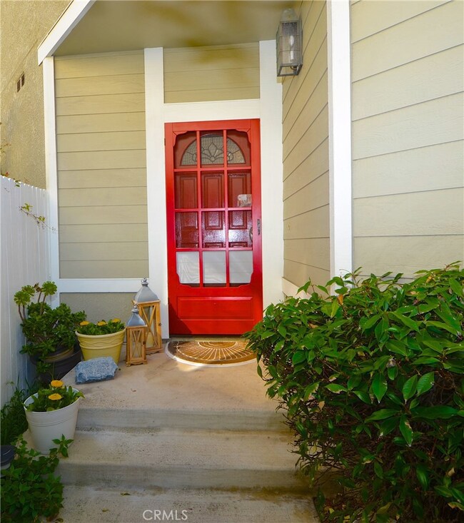 CUSTOM RED FRONT AND SCREEN DOORS GREET YOU