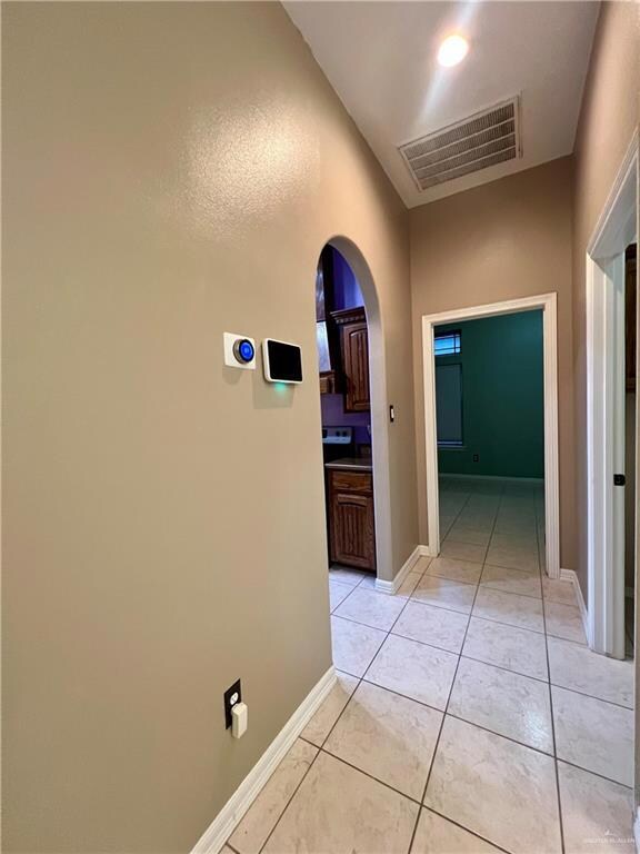 Corridor featuring light tile patterned floors
