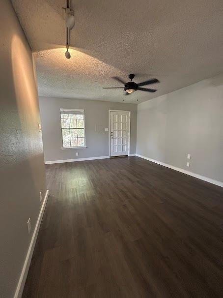 Empty room with dark wood finished floors, a text