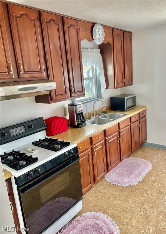 Kitchen featuring wood cabinets.