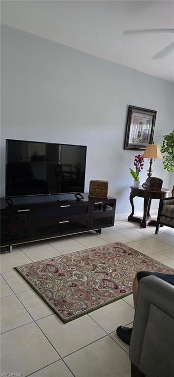 Living area featuring light tile patterned flooring and ceiling fan