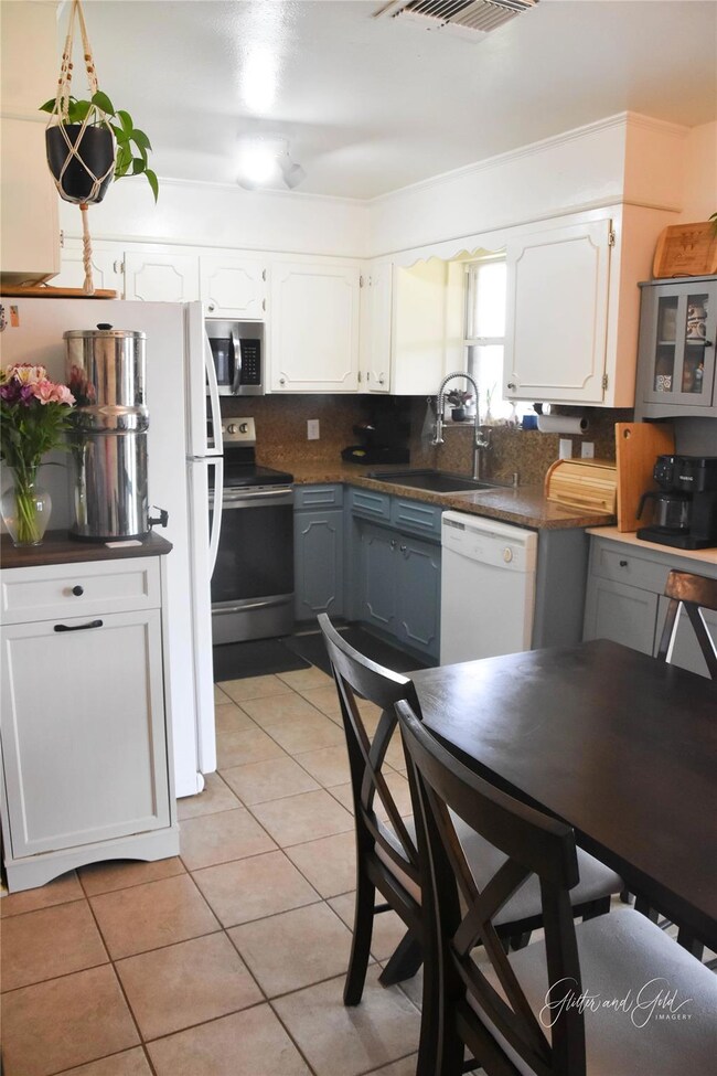 Kitchen with a sink, appliances with stainless ste