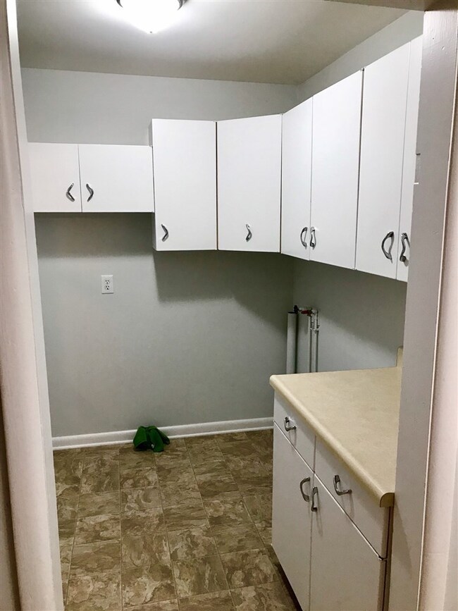 nice laundry with additional cabinets and new floo