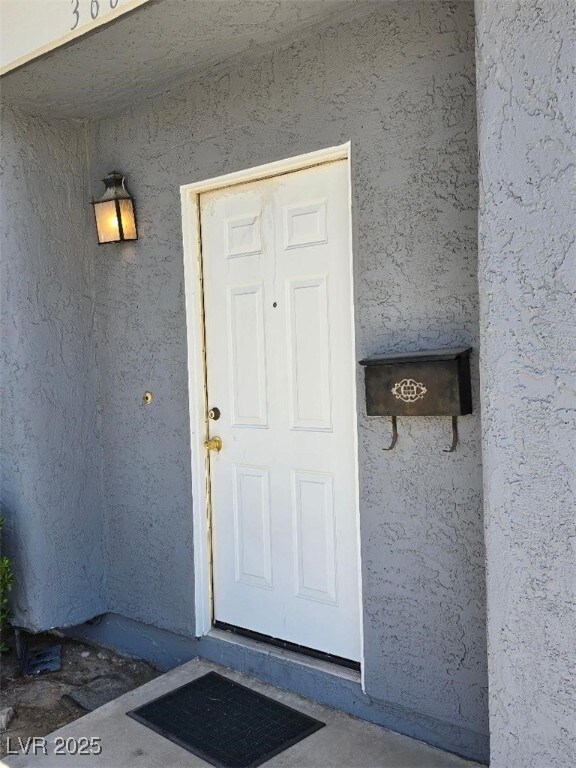 View of exterior entry with stucco siding