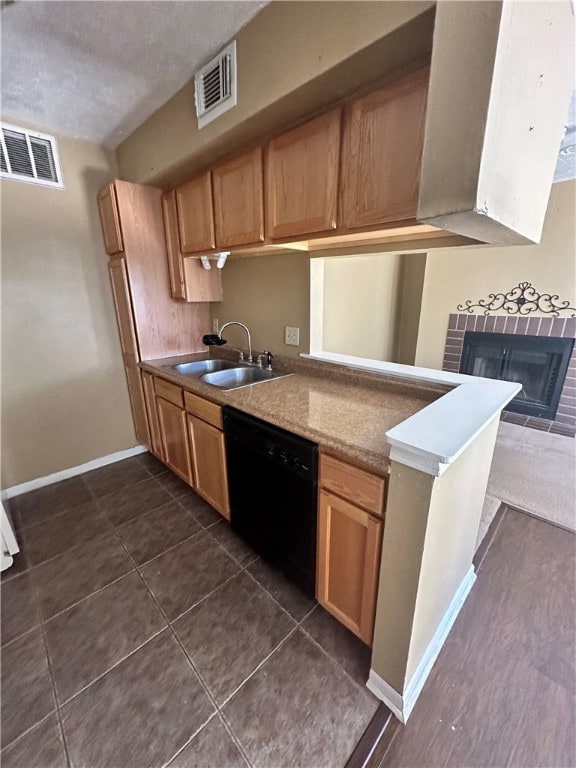Kitchen with black dishwasher, visible vents, a si