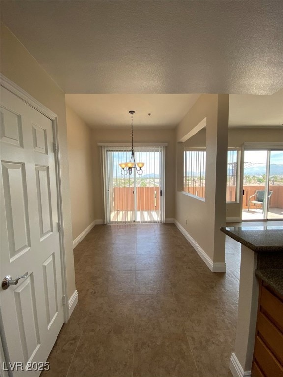 Unfurnished dining area with an inviting chandelie