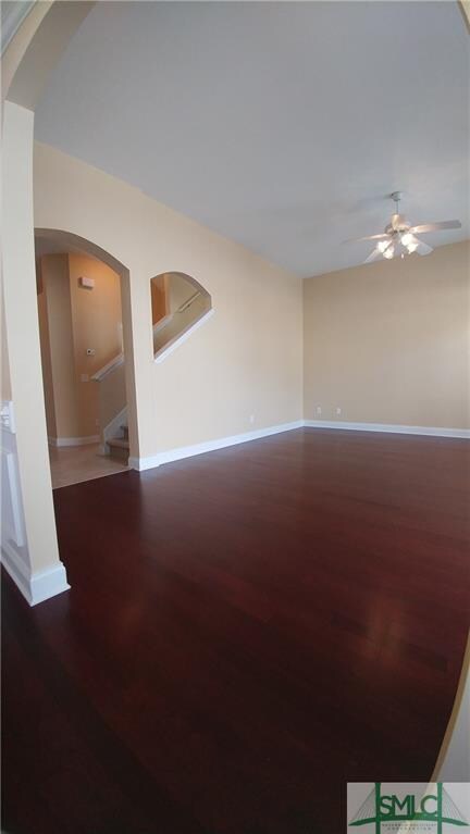 Great room with cherry flooring and steps to upsta