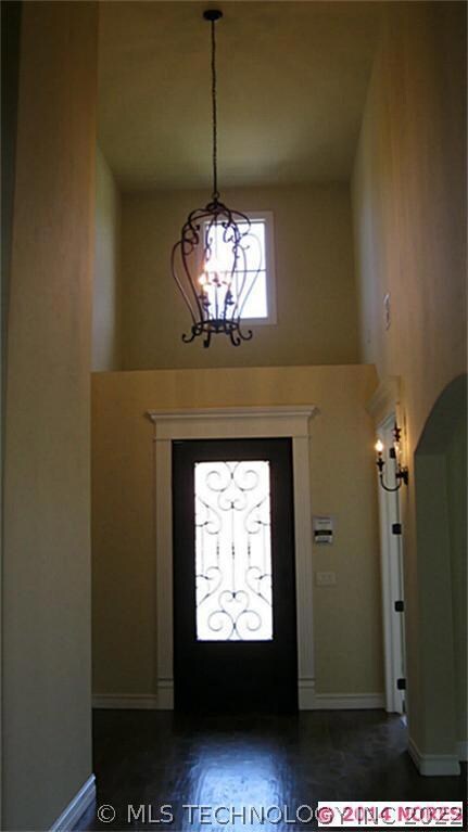 Wonderful two story entry, wrought iron door and H