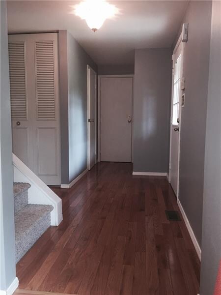 Entry way with hardwood floors and fresh neutral p